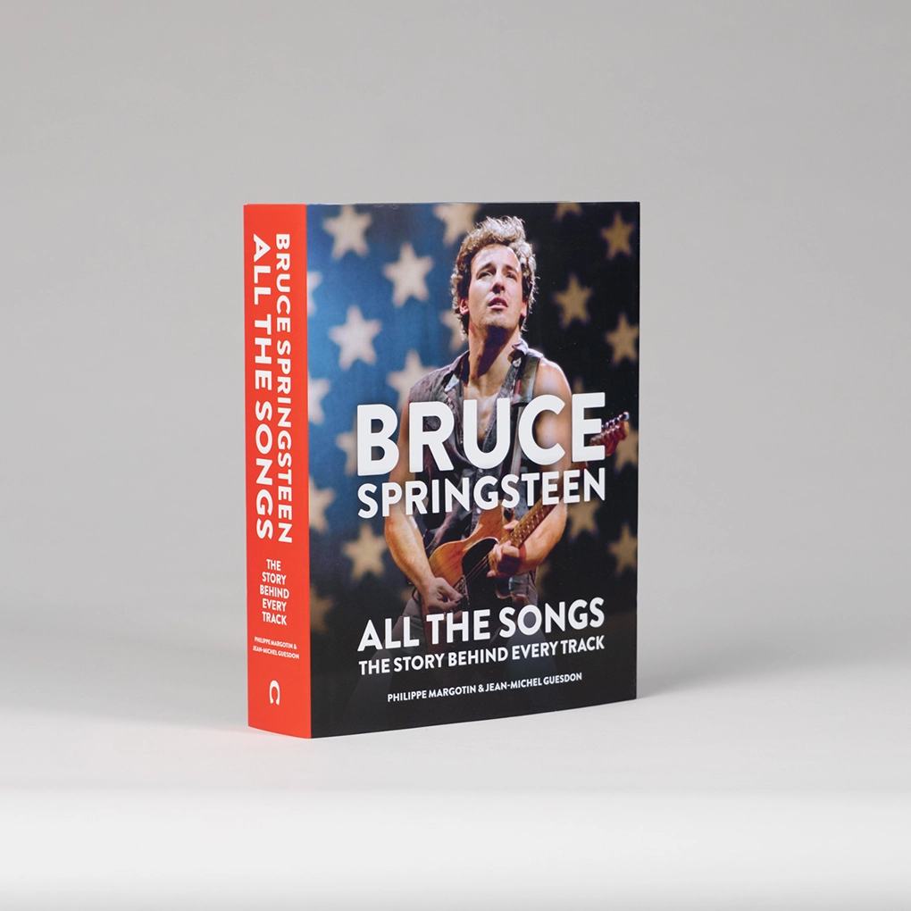 The book is angled to show the red spine